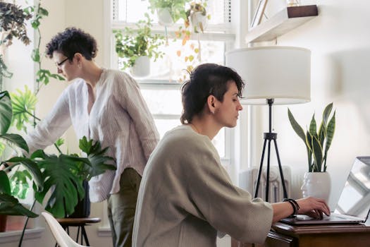 a cozy desk with succulents and a laptop