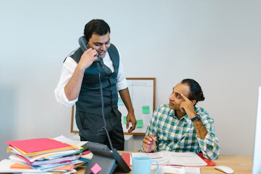 A busy office environment showing professionals taking a moment to breathe