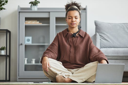 a person meditating at their desk