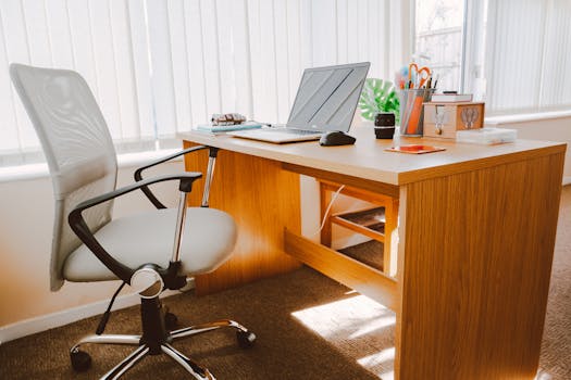 a desk with plants and a tidy workspace